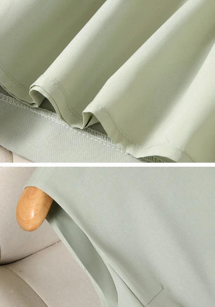 Sage green FJØRNA women's dress with a flowing silhouette, long sleeves, and a V-neckline, perfect for casual or semi-formal wear.