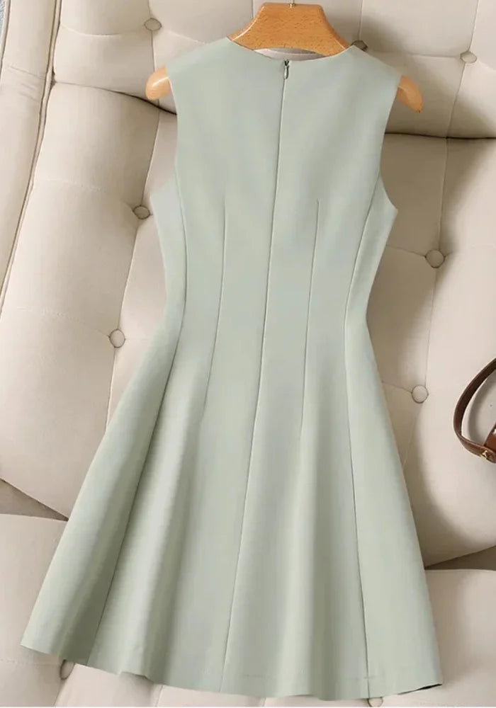 Sage green FJØRNA women's dress with flowing fabric and long sleeves, styled for casual or semi-formal wear.