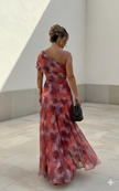 Flowy summer mini dress for women by FJØRNA, featuring a vibrant red pattern and casual, breezy style.
