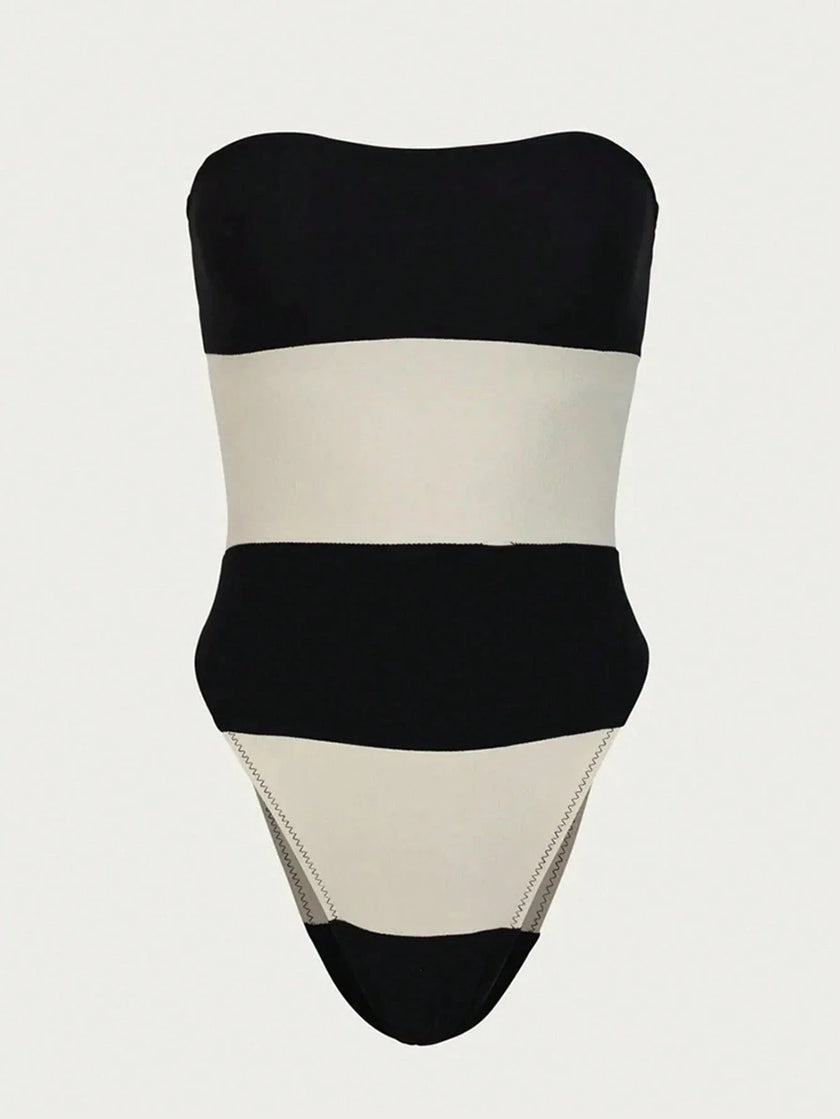 Women's off-shoulder striped jumpsuit with high leg cut and contrast stripes, by FJØRNA, featuring a stylish, modern design.