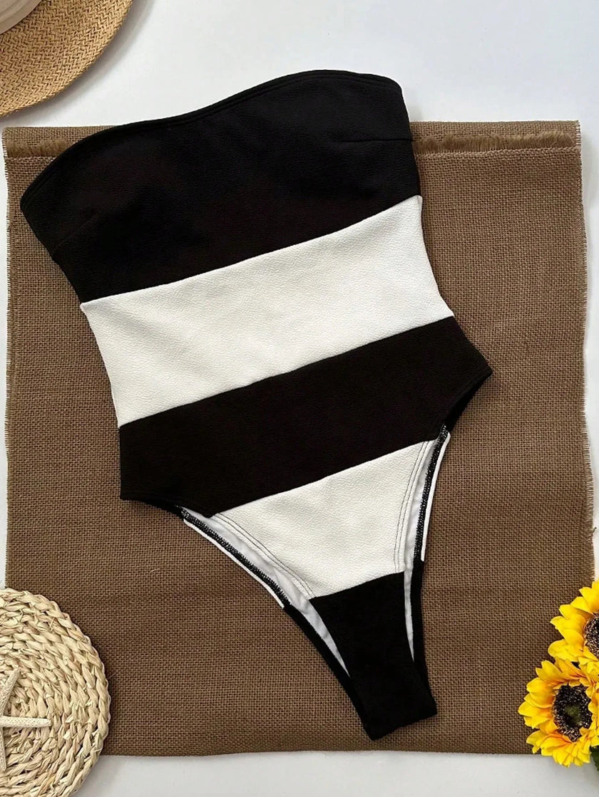 Women's off-shoulder striped jumpsuit with high leg cut and contrast stripes, by FJØRNA, featuring a stylish, relaxed fit.