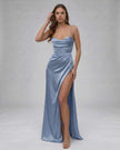 Blue satin maxi dress for women by FJØRNA featuring a high slit and elegant silhouette with a silky finish.