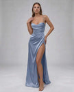 Light blue satin maxi dress by FJØRNA featuring a high slit, elegant flowing silhouette, perfect for formal occasions.