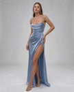 Elegant blue satin maxi dress for women by FJØRNA featuring a high slit and sophisticated, fashion-forward design.