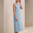 Side view of FJØRNA elegant sleeveless midi dress for women with a V-neck, showcasing a flowing fabric and stylish design.