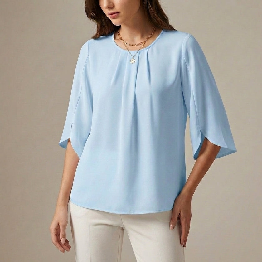 Sky blue pleated summer blouse for women from FJØRNA, casual top with lightweight fabric and stylish design.