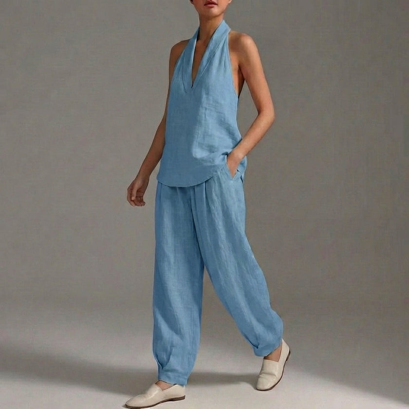 Sky blue FJØRNA two-piece halter V-neck swimsuit with wide-leg trousers, featuring a fitted top and flowing pants.