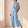 Sky blue FJØRNA women's two-piece co-ord set with ruffle high neck top and matching pants, stylish and elegant outfit.