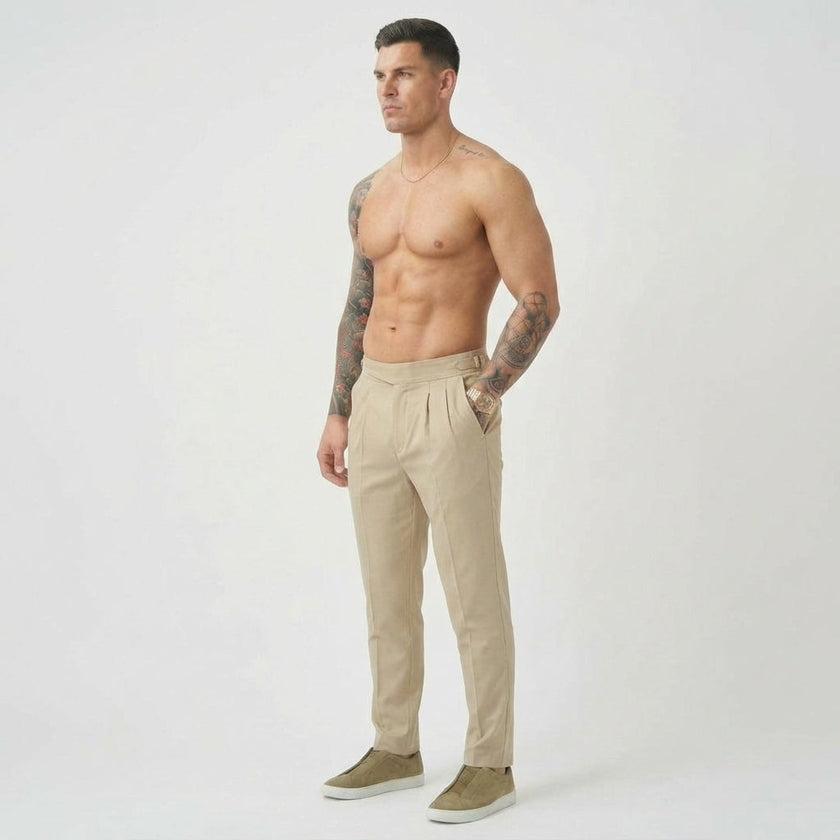 Cream tailored trousers by FJØRNA, featuring a fitted waist and classic straight-leg design, displayed on a model.