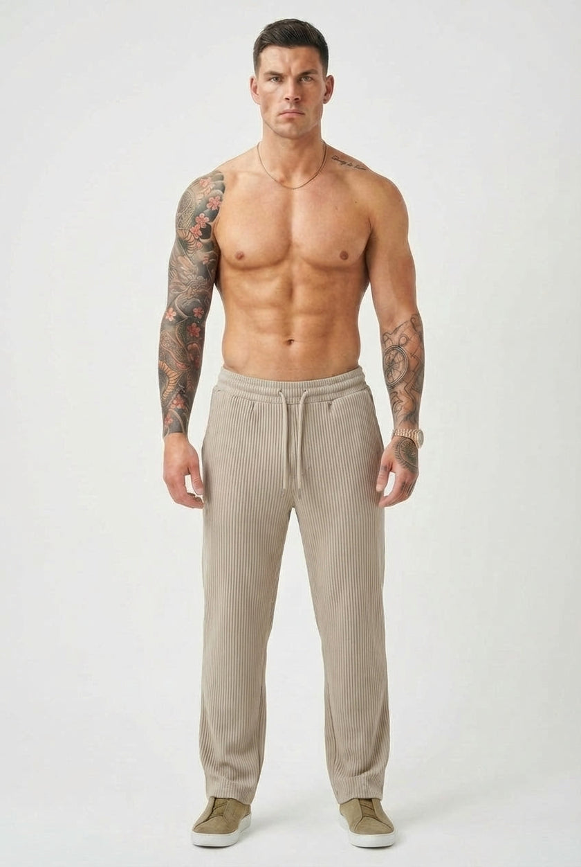 FJØRNA relaxed knit khaki trousers displayed on a model, showcasing comfortable, casual style and soft fabric.