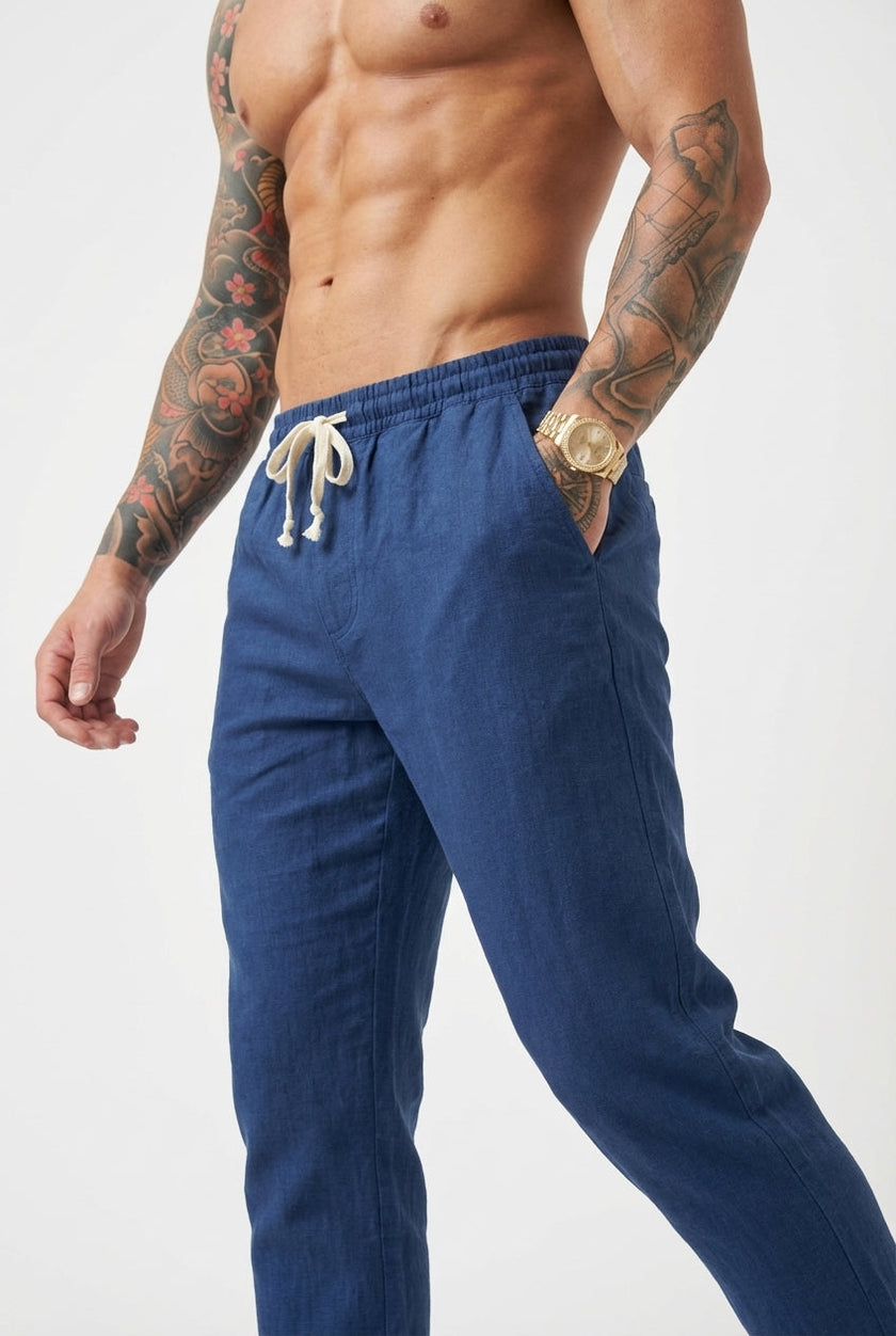 FJØRNA linen tailored trousers in beige, featuring a high-waisted design and clean, straight-leg fit, displayed on a model.