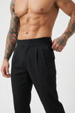 FJØRNA tailored black trousers displayed on a model, showing a slim fit and classic design suitable for professional or casual wear.