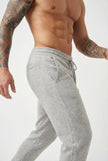 FJØRNA Merino Wool Trousers in light grey, tailored fit, showing the soft wool fabric and classic design.