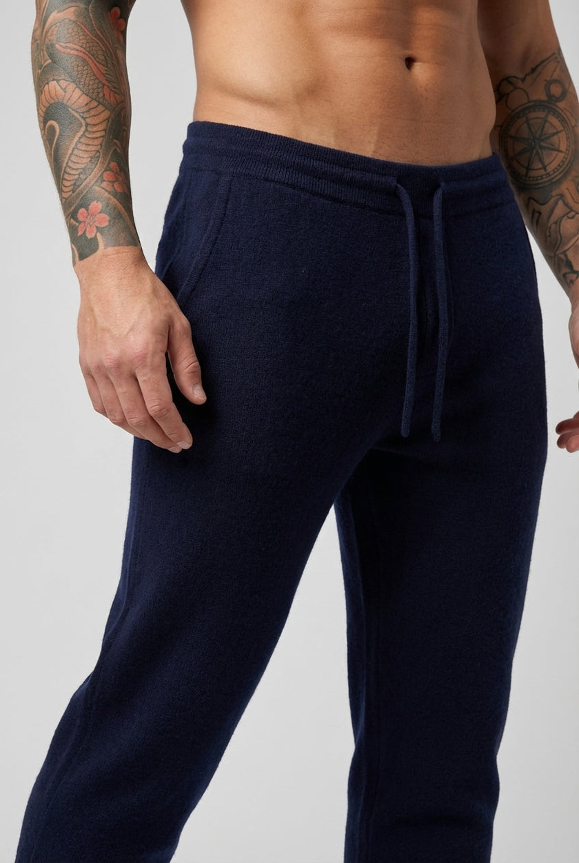 FJØRNA navy merino wool trousers displayed on a model, showcasing their tailored fit and soft fabric for casual or professional wear.