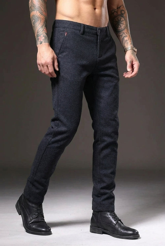 FJØRNA men's slim-fit blue trousers displayed on a model, showcasing modern tailored pants with a sleek fit.