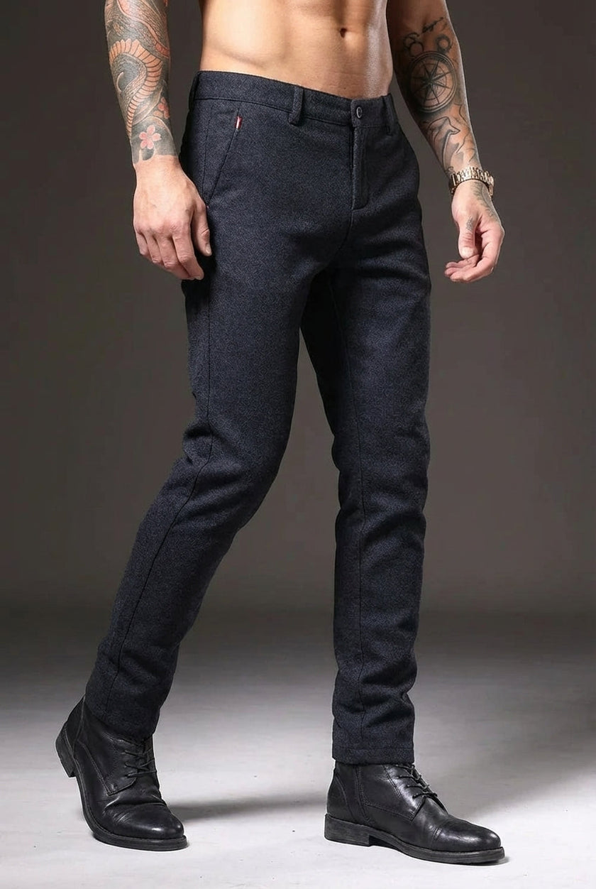 Slim-fit blue trousers by FJØRNA, showcasing the tailored design and sleek fit on a model.
