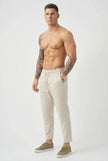 FJØRNA cropped linen trousers in indigo color, featuring a relaxed fit and lightweight fabric, perfect for casual wear.