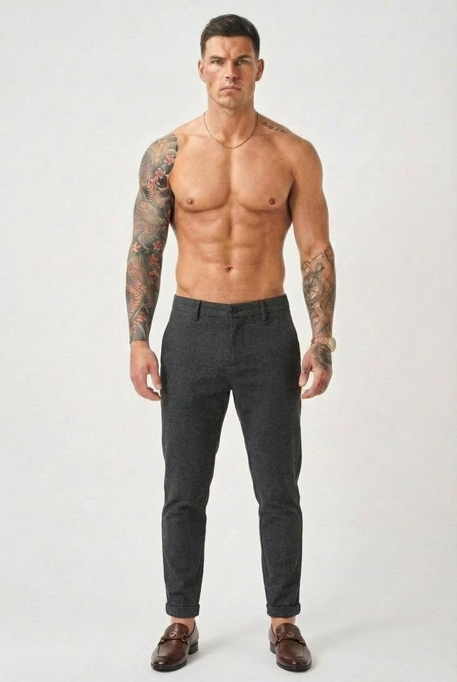 Black slim-fit men's trousers by FJØRNA, shown in a stylish image highlighting the tailored fit and sleek design.