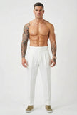 White tailored trousers by FJØRNA, showing a close-up of the sleek, fitted design and smooth fabric.