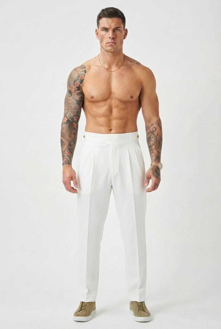 White tailored trousers by FJØRNA, showing a close-up of the sleek, fitted design and smooth fabric.