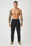 Black tailored trousers by FJØRNAs, featuring a slim fit and classic design, displayed on a model.