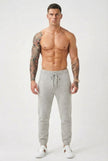 Light grey Merino Wool trousers by FJØRNA, showing a close-up of the soft, fitted fabric and tailored waistband.