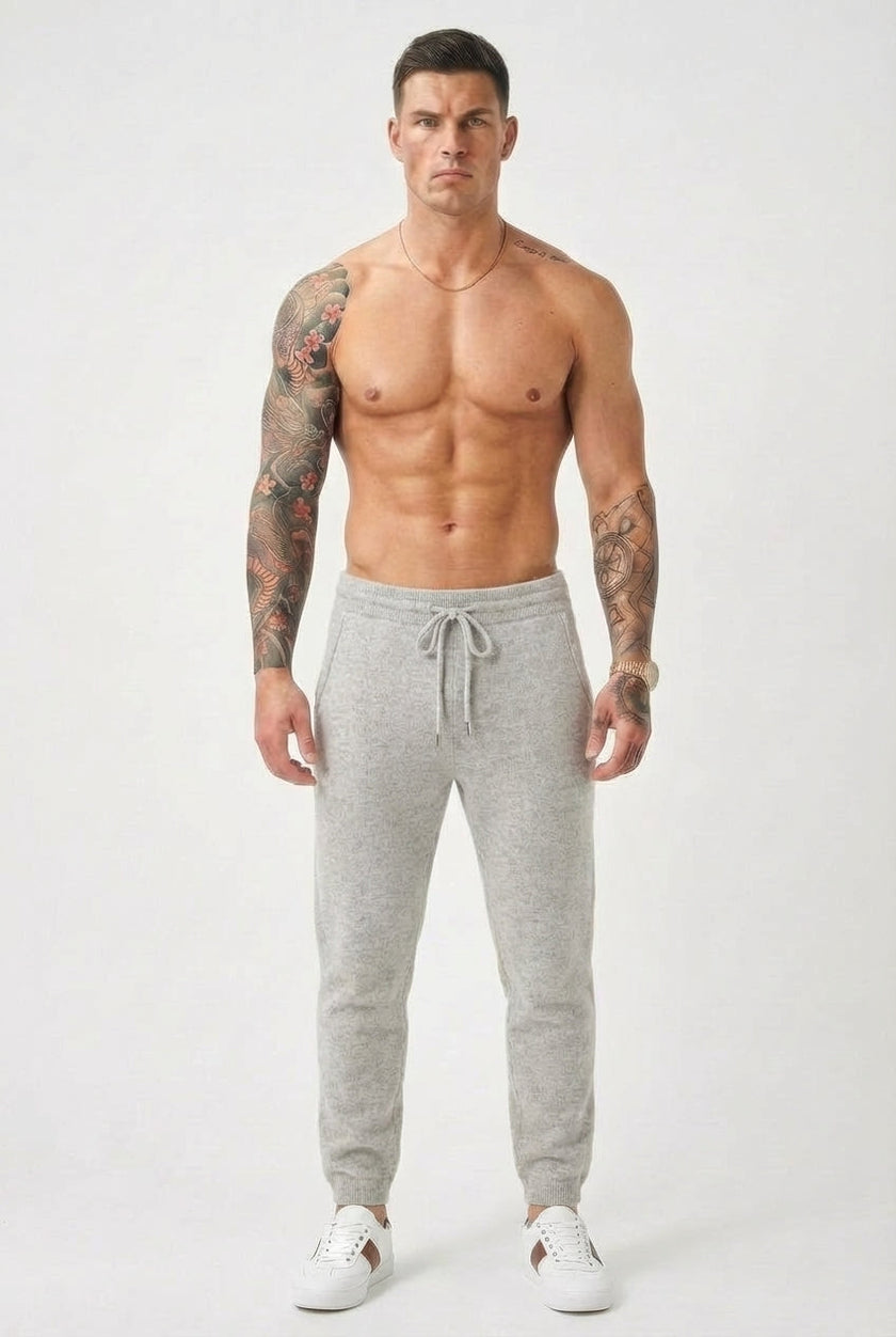Light grey Merino Wool trousers by FJØRNA, showing a close-up of the soft, fitted fabric and tailored waistband.