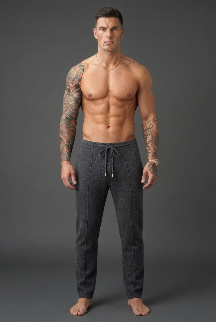 Dark grey Merino wool trousers by FJØRNA displayed on a model, highlighting their tailored fit and soft, high-quality fabric.
