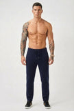 FJØRNA navy merino wool trousers laid flat, showing the tailored fit and soft fabric texture.