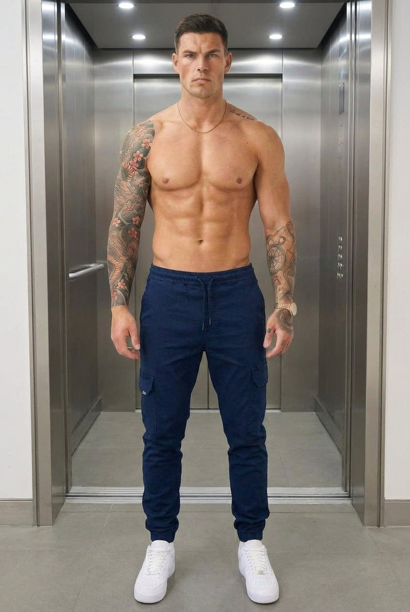 FJØRNA navy cargo jogger trousers displayed on a model, featuring relaxed fit, multiple pockets, and drawstring waist for casual style.