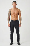 FJØRNA slim-fit blue trousers displayed on a model, showing the tailored fit and fabric detail.