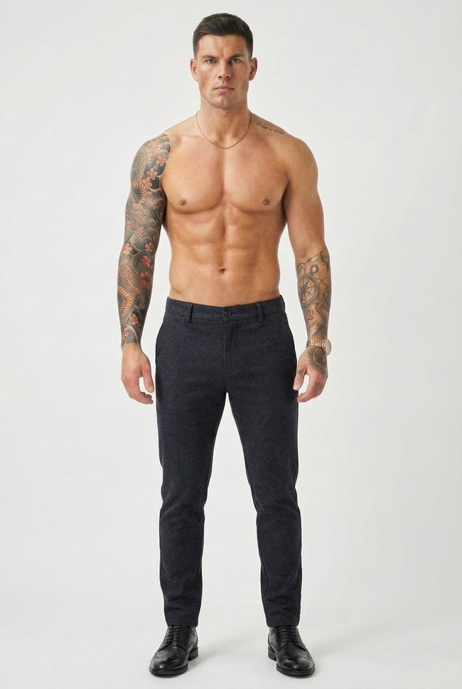 Men's slim-fit blue trousers by FJØRNA, tailored fit with front pockets, shown on a model against a neutral background.