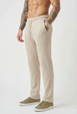 FJØRNA relaxed knit khaki trousers displayed on a model, featuring a casual fit and soft knit fabric for comfortable wear.
