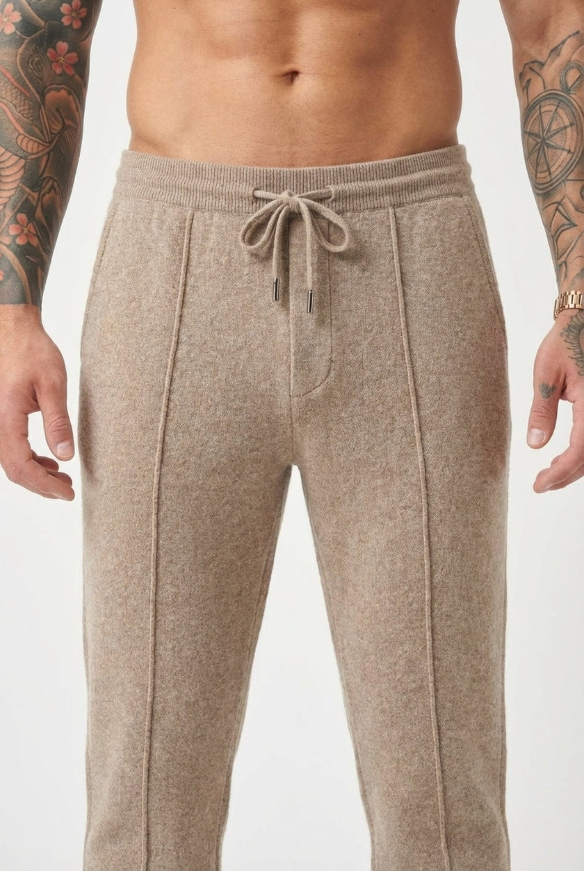 Beige merino wool trousers by FJØRNA displayed on a model, highlighting the soft fabric and tailored fit.