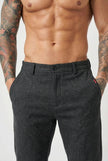 Black slim-fit trousers by FJØRNA, displayed on a model, showcasing a tailored, modern fit and sleek design.