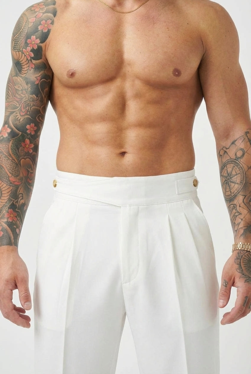 White tailored trousers by FJØRNA, featuring a sleek fit and classic design, shown on a model in a professional setting.