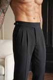 FJØRNA tailored black trousers featuring a slim fit design, shown on a model with a classic waistband and sleek silhouette.