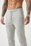 Light grey merino wool trousers by FJØRNA, showing tailored fit and soft fabric texture in a fashion-forward style.