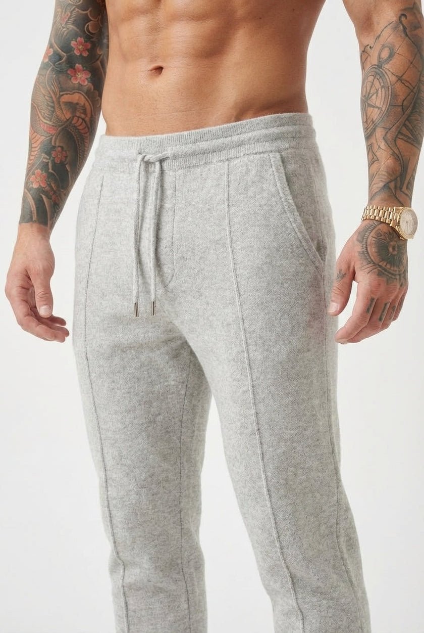 Light grey merino wool trousers by FJØRNA, showing tailored fit and soft fabric texture in a fashion-forward style.