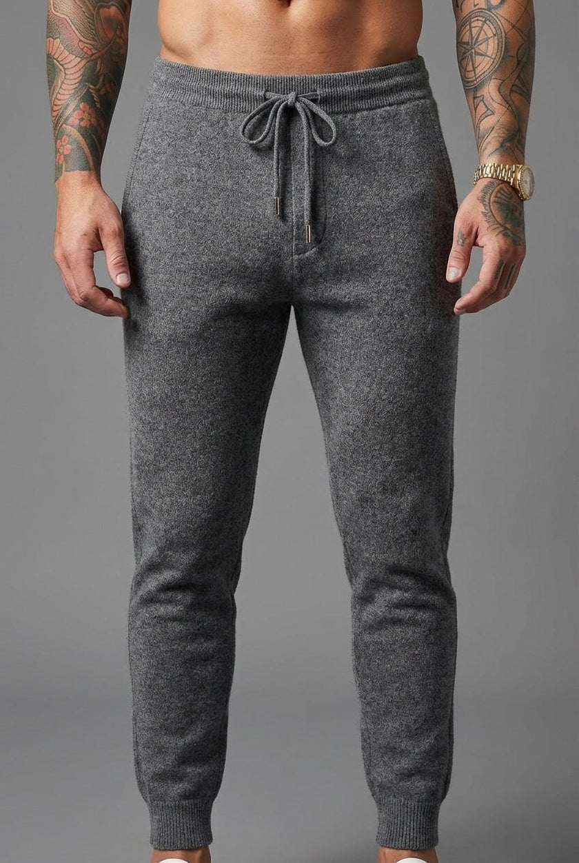 FJØRNA merino wool trousers in dark grey, tailored fit, featuring side pockets and a smooth waistband, suitable for casual or office wear.