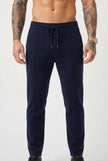 Navy Merino wool trousers by FJØRNA, featuring a tailored fit and classic design, displayed on a model.