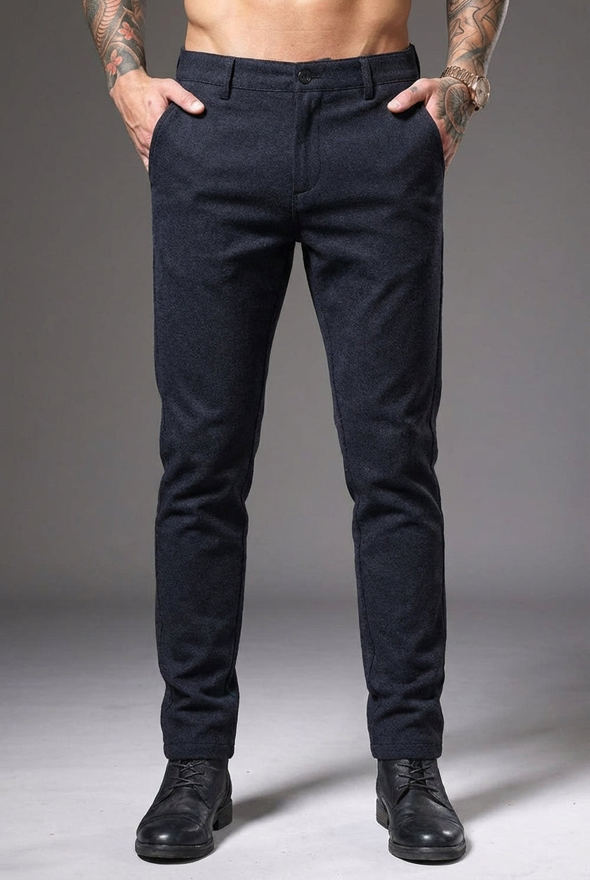 Blue slim-fit trousers by FJØRNA displayed on a model, showcasing a tailored, modern fit and sleek design.