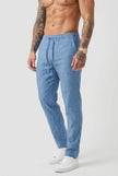Beige relaxed linen trousers by FJØRNA, stylish and comfortable, shown on a model with a casual fit and soft fabric texture.