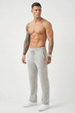 Light grey FJØRNA Merino wool trousers displayed on a hanger, showcasing their tailored fit and soft fabric texture.