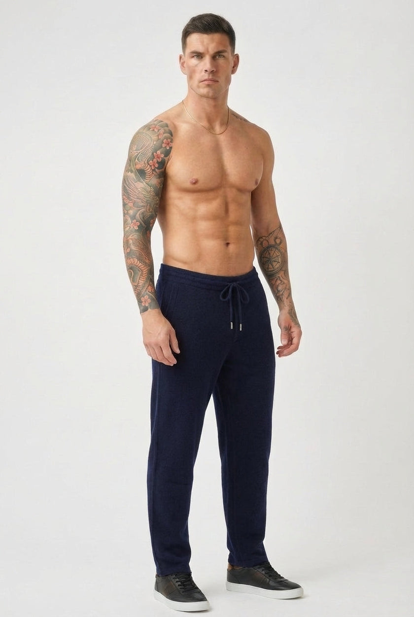 FJØRNA navy merino wool trousers displayed on a model, showcasing tailored fit and soft, high-quality wool fabric.