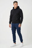 FJØRNA navy cargo jogger trousers with multiple pockets, relaxed fit, and adjustable drawstring waistband, shown on a model.