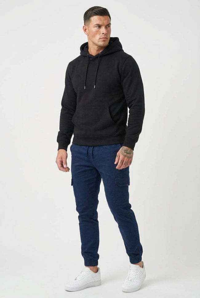 Men's navy cargo jogger trousers by FJØRNA featuring relaxed fit, multiple pockets, and comfortable fabric for casual wear.