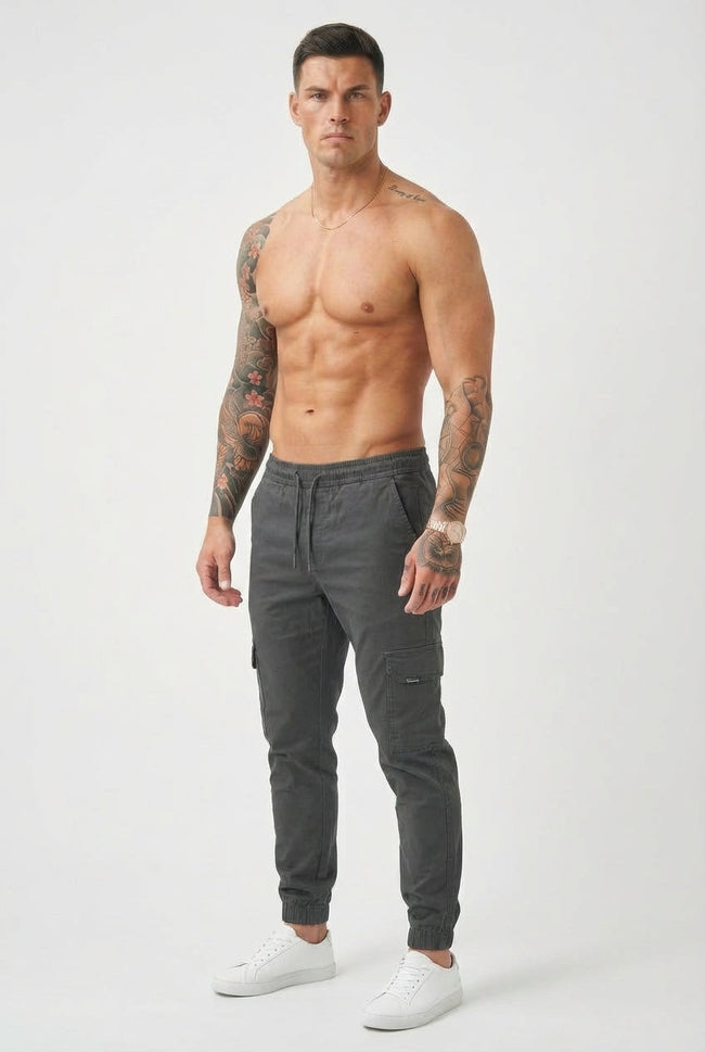 Men's grey cargo jogger trousers by FJØRNA, featuring a relaxed fit with multiple pockets and comfortable fabric for casual wear.