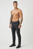 Slim-fit blue trousers by FJØRNA shown on a model, featuring a tailored fit and classic design for casual or formal wear.