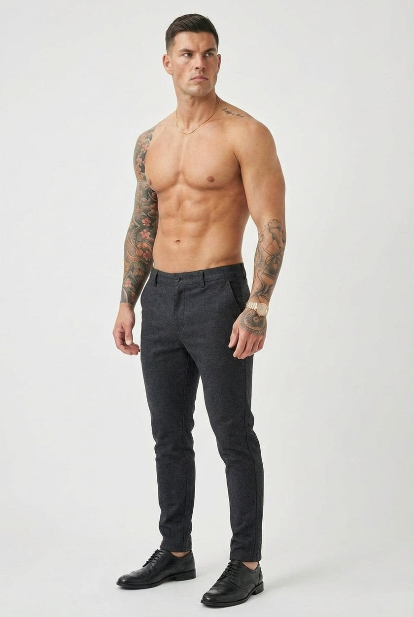 Slim-fit blue trousers by FJØRNA shown on a model, featuring a tailored fit and classic design for casual or formal wear.